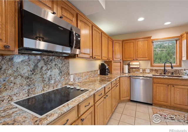 366 N Rim Rd, Livermore, CO 80536 - kitchen featuring stainless steel appliances, tasteful backsplash, light tile patterned flooring, light stone countertops, and recessed lighting
