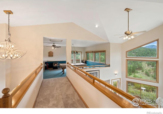 366 N Rim Rd, Livermore, CO 80536 - hallway with light colored carpet, vaulted ceiling, and a chandelier