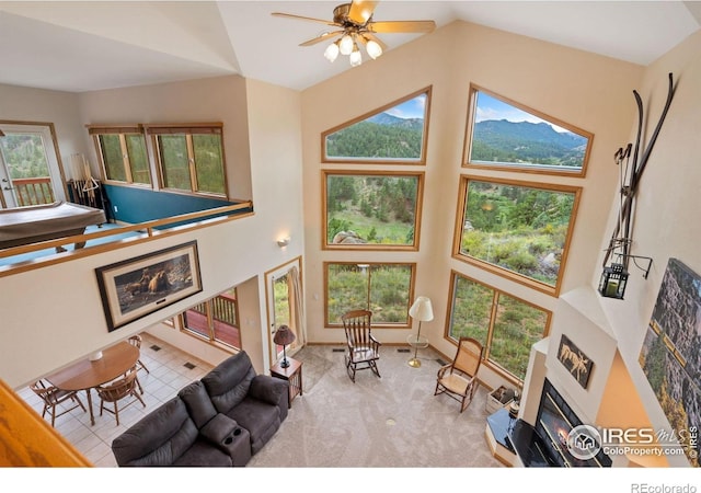 366 N Rim Rd, Livermore, CO 80536 - carpeted living area featuring high vaulted ceiling, ceiling fan, and a glass covered fireplace