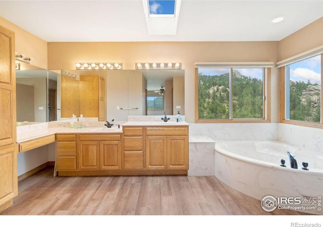 366 N Rim Rd, Livermore, CO 80536 - full bathroom with wood finished floors, a garden tub, and double vanity