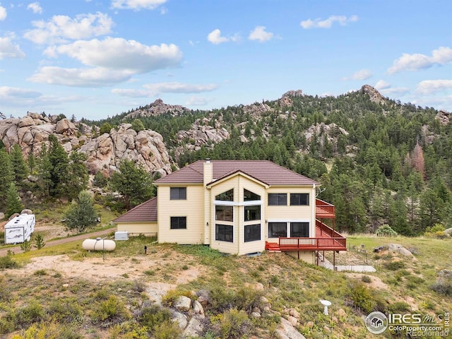 366 N Rim Rd, Livermore, CO 80536 - back of house featuring a forest view and a deck with mountain view