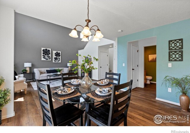 7266 Andover St, Wellington, CO 80549 - dining room with wood finished floors and a chandelier