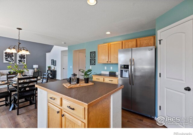 7266 Andover St, Wellington, CO 80549 - kitchen with stainless steel refrigerator with ice dispenser, dark countertops, dark wood-style floors, a chandelier, and recessed lighting
