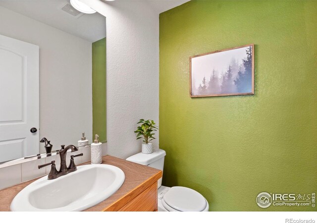 7266 Andover St, Wellington, CO 80549 - bathroom featuring vanity and a textured wall