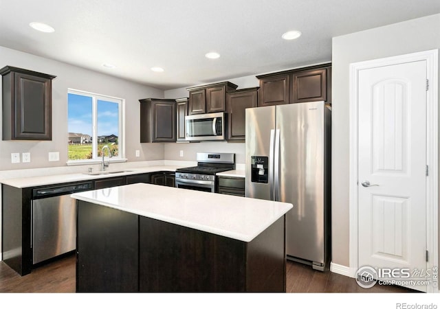 5562 Bristow Rd, Timnath, CO 80547 - kitchen featuring appliances with stainless steel finishes, dark wood-type flooring, dark brown cabinets, light countertops, and recessed lighting