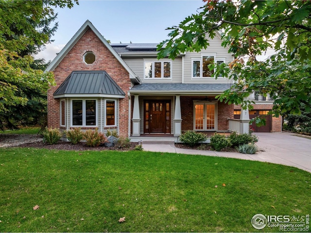 1107 Juniper Ave, Boulder, CO 80304 - view of front of home with a front yard, brick siding, solar panels, and driveway