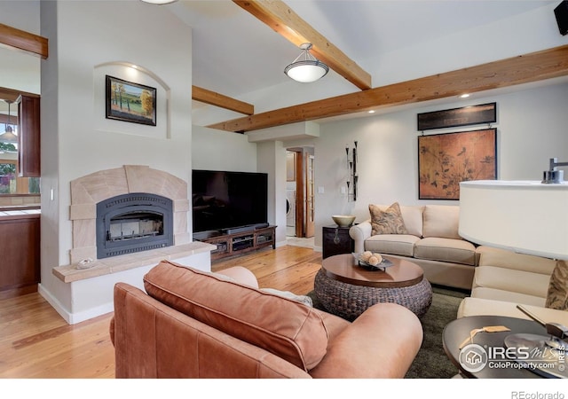 9445 Lykins Pl, Boulder, CO 80301 - living area featuring light wood-style flooring, beamed ceiling, a tile fireplace, and recessed lighting