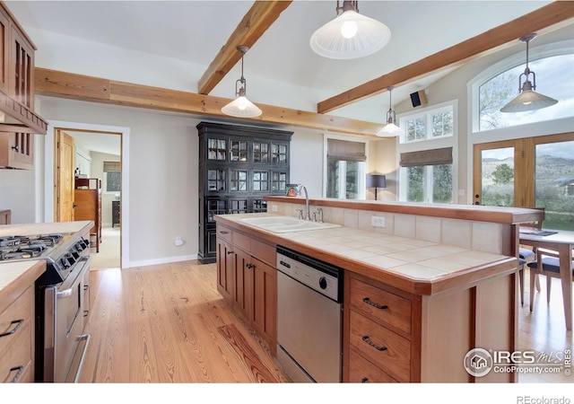 9445 Lykins Pl, Boulder, CO 80301 - kitchen with stainless steel appliances, tile counters, light wood-type flooring, and healthy amount of natural light
