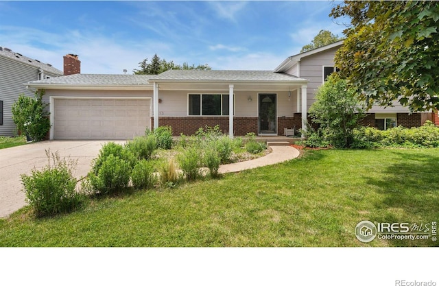 2013 Ridgewood Rd, Fort Collins, CO 80526 - tri-level home with brick siding, a garage, a front yard, and driveway