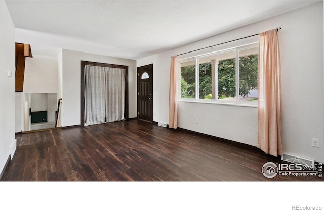 2013 Ridgewood Rd, Fort Collins, CO 80526 - unfurnished living room with dark wood finished floors and baseboards