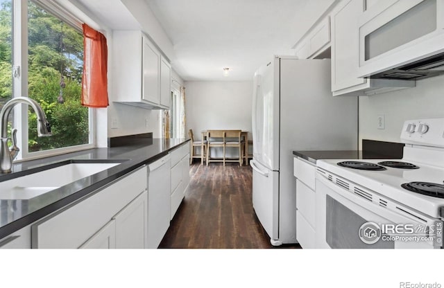 2013 Ridgewood Rd, Fort Collins, CO 80526 - kitchen with white appliances, dark countertops, white cabinetry, dark wood finished floors, and plenty of natural light