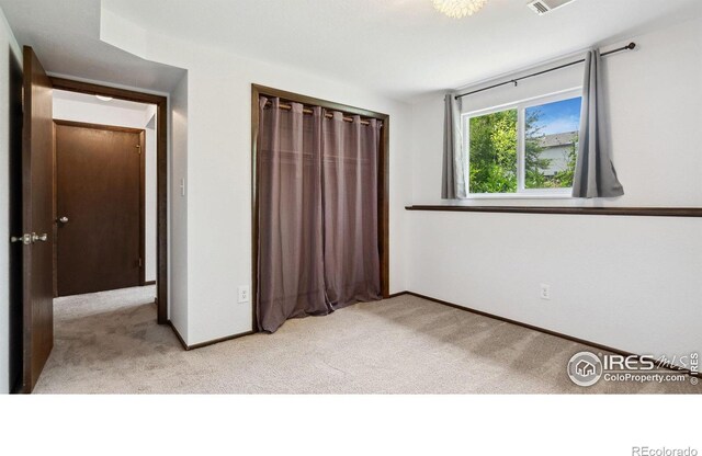 2013 Ridgewood Rd, Fort Collins, CO 80526 - unfurnished bedroom featuring light colored carpet and a closet