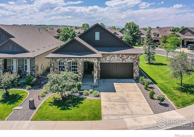 2050 Vineyard Dr, Windsor, CO 80550 - view of front of property with a garage, stone siding, a front lawn, and concrete driveway