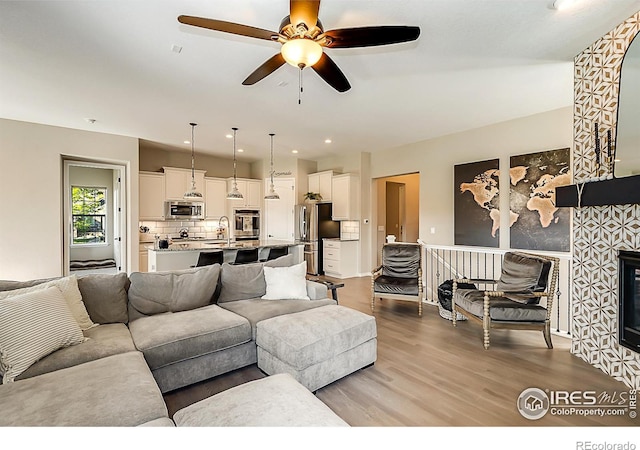 2050 Vineyard Dr, Windsor, CO 80550 - living area featuring wood finished floors and a ceiling fan