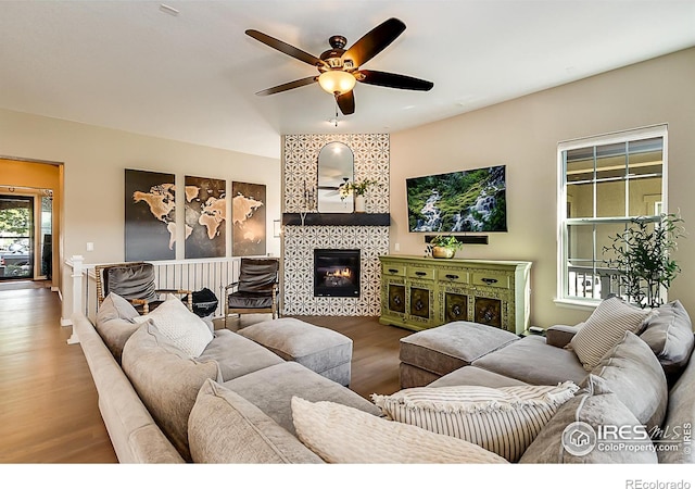 2050 Vineyard Dr, Windsor, CO 80550 - living area featuring a ceiling fan, wood finished floors, and a fireplace