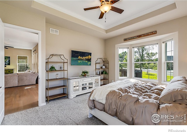 2050 Vineyard Dr, Windsor, CO 80550 - carpeted bedroom with ornamental molding and a tray ceiling