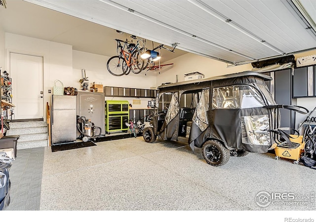 2050 Vineyard Dr, Windsor, CO 80550 - garage featuring freestanding refrigerator and a garage door opener