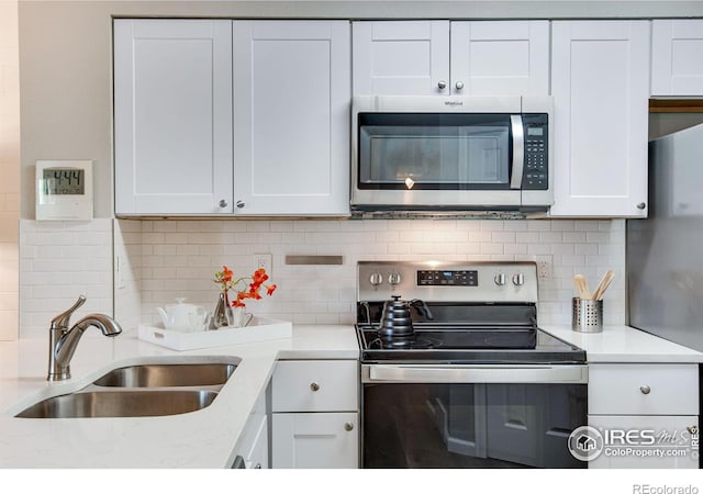 4763 White Rock Cir Unit A, Boulder, CO 80301 - kitchen with stainless steel appliances, white cabinets, and decorative backsplash