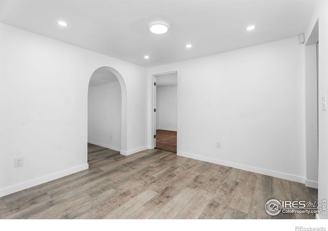 1111 Wabash St, Denver, CO 80220 - unfurnished room featuring arched walkways, wood finished floors, and recessed lighting
