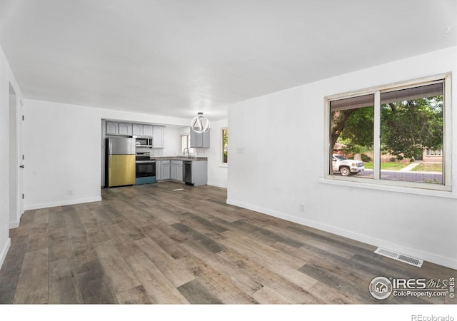 1111 Wabash St, Denver, CO 80220 - unfurnished living room with dark wood finished floors