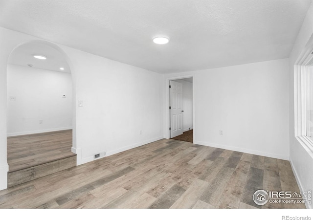 1111 Wabash St, Denver, CO 80220 - unfurnished room with arched walkways, wood finished floors, and recessed lighting