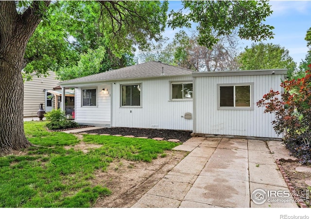 1111 Wabash St, Denver, CO 80220 - view of front facade with a patio and a shingled roof