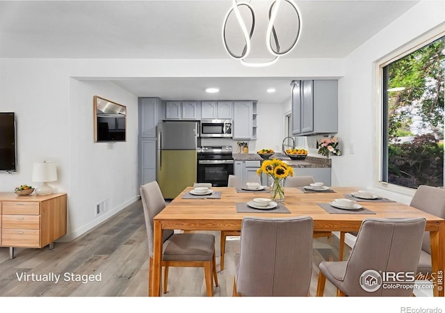 1111 Wabash St, Denver, CO 80220 - dining room featuring light wood-style floors and recessed lighting