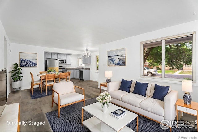 1111 Wabash St, Denver, CO 80220 - living room featuring plenty of natural light and dark wood finished floors