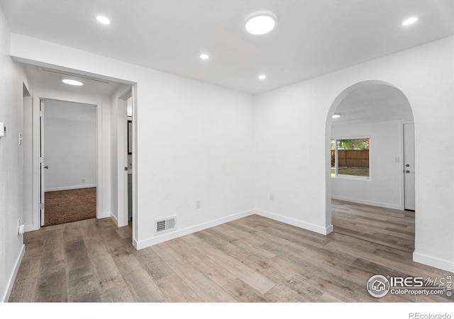 1111 Wabash St, Denver, CO 80220 - spare room with arched walkways, wood finished floors, and recessed lighting