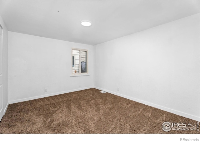 1111 Wabash St, Denver, CO 80220 - spare room with dark colored carpet and baseboards