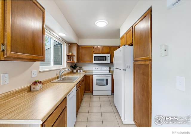 4255 Westshore Way Unit 19, Fort Collins, CO 80525 - kitchen featuring white appliances, brown cabinetry, light tile patterned flooring, and light countertops
