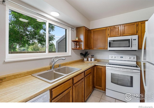 4255 Westshore Way Unit 19, Fort Collins, CO 80525 - kitchen with white appliances, light countertops, brown cabinets, and light tile patterned floors