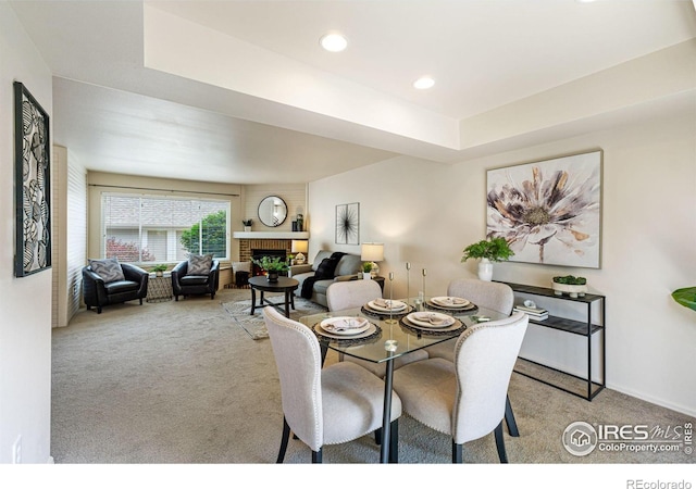 4255 Westshore Way Unit 19, Fort Collins, CO 80525 - carpeted dining space featuring a fireplace, a tray ceiling, and recessed lighting