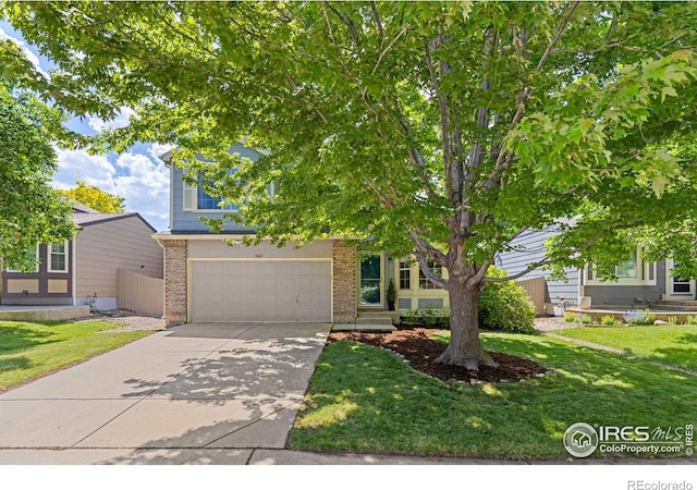 1667 Reliance Cir, Superior, CO 80027 - obstructed view of property featuring brick siding, driveway, a garage, and a front lawn
