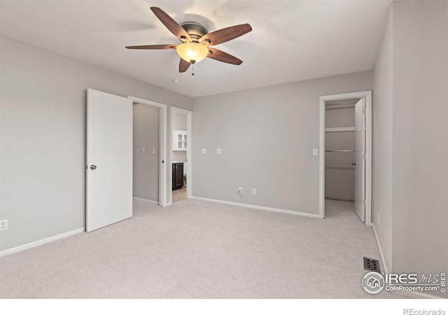 1667 Reliance Cir, Superior, CO 80027 - unfurnished bedroom featuring light colored carpet, a spacious closet, and a ceiling fan