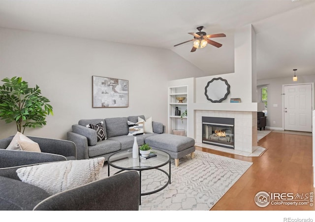 1667 Reliance Cir, Superior, CO 80027 - living area featuring a ceiling fan, wood finished floors, lofted ceiling, and a tiled fireplace