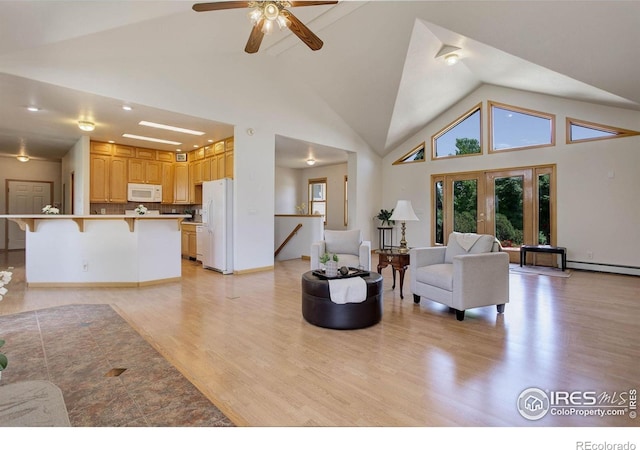 8943 Gander Valley Ln, Windsor, CO 80550 - living room featuring light wood finished floors, ceiling fan, baseboard heating, and high vaulted ceiling