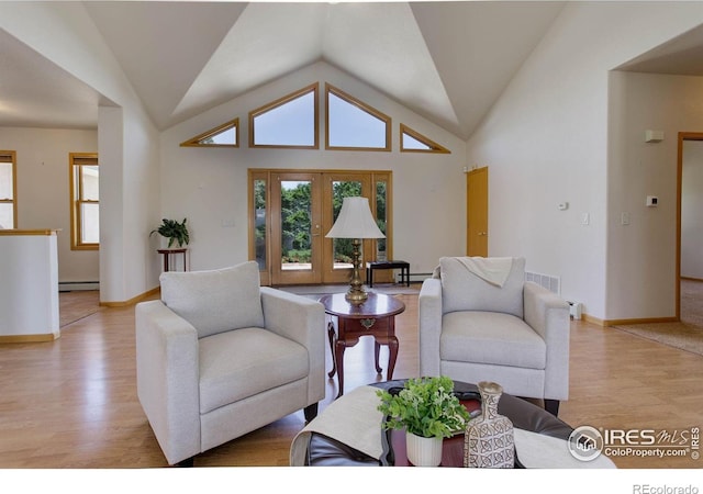 8943 Gander Valley Ln, Windsor, CO 80550 - living room featuring light wood-type flooring, vaulted ceiling, and a baseboard radiator