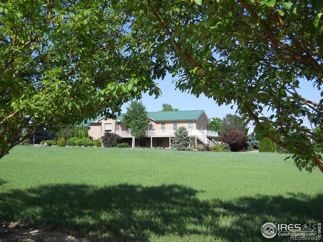 8943 Gander Valley Ln, Windsor, CO 80550 - view of grassy yard featuring a wooden deck