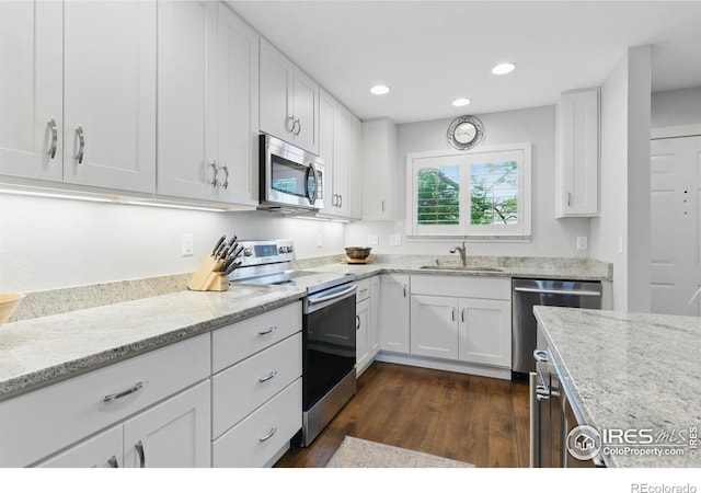 4255 Westshore Way Unit B4, Fort Collins, CO 80525 - kitchen featuring stainless steel appliances, white cabinetry, light stone counters, dark wood-style floors, and recessed lighting