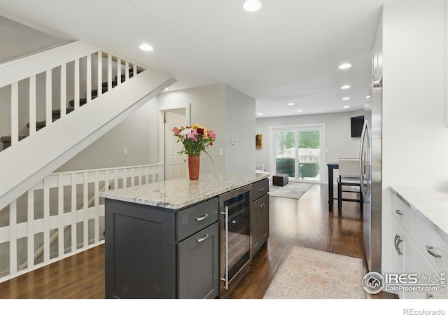 4255 Westshore Way Unit B4, Fort Collins, CO 80525 - kitchen featuring beverage cooler, dark wood-style floors, freestanding refrigerator, light stone countertops, and recessed lighting