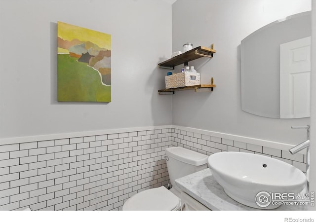 4255 Westshore Way Unit B4, Fort Collins, CO 80525 - half bathroom featuring tile walls, a wainscoted wall, and vanity