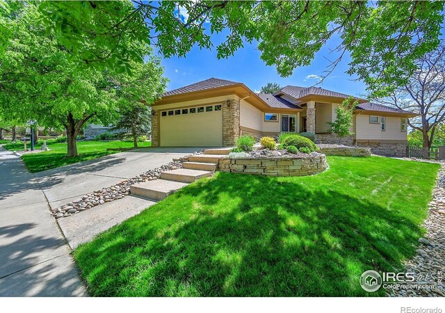 2226 Eagles Nest Dr, Lafayette, CO 80026 - view of front of house with stone siding, an attached garage, concrete driveway, and a front yard