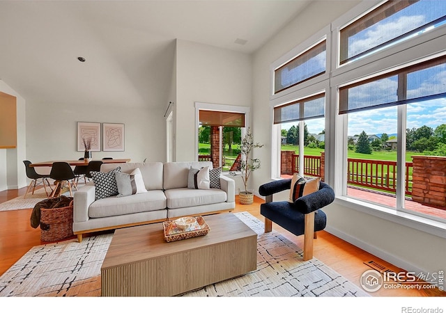 2226 Eagles Nest Dr, Lafayette, CO 80026 - living room featuring light wood finished floors and a towering ceiling