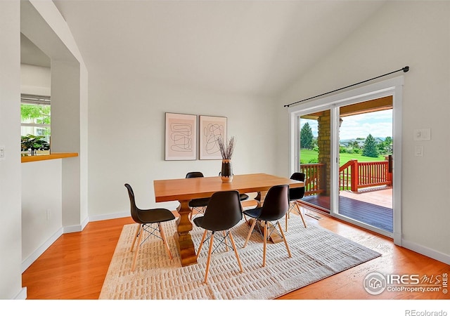 2226 Eagles Nest Dr, Lafayette, CO 80026 - dining area featuring plenty of natural light, light wood finished floors, and lofted ceiling