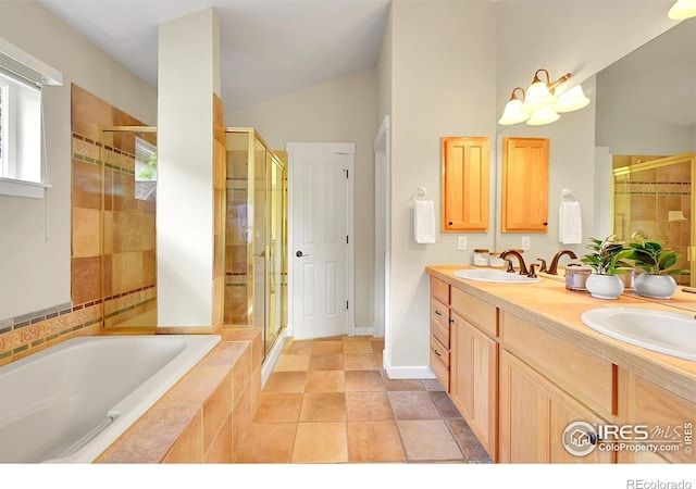 2226 Eagles Nest Dr, Lafayette, CO 80026 - bathroom featuring a stall shower, a bath, double vanity, and vaulted ceiling