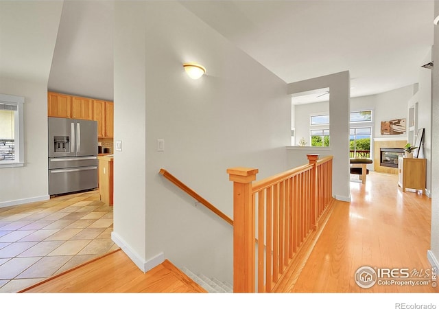 2226 Eagles Nest Dr, Lafayette, CO 80026 - hall featuring an upstairs landing, light wood finished floors, and vaulted ceiling