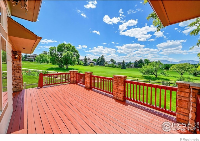 2226 Eagles Nest Dr, Lafayette, CO 80026 - wooden terrace with a yard, a mountain view, and view of golf course