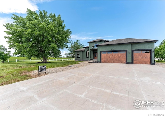 5217 Dry Creek Rd, Evans, CO 80634 - view of front of house with driveway, an attached garage, and stucco siding