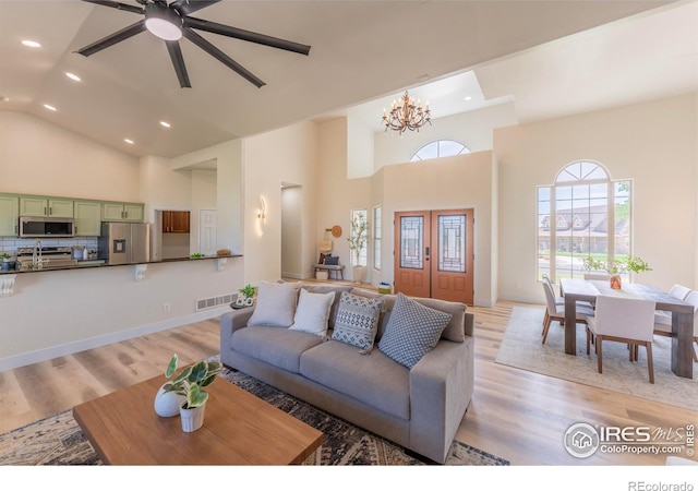 5217 Dry Creek Rd, Evans, CO 80634 - living area featuring recessed lighting, high vaulted ceiling, light wood-type flooring, a ceiling fan, and a chandelier